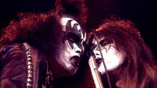Gene Simmons and Ace Frehley sharing a mic onstage in 1978