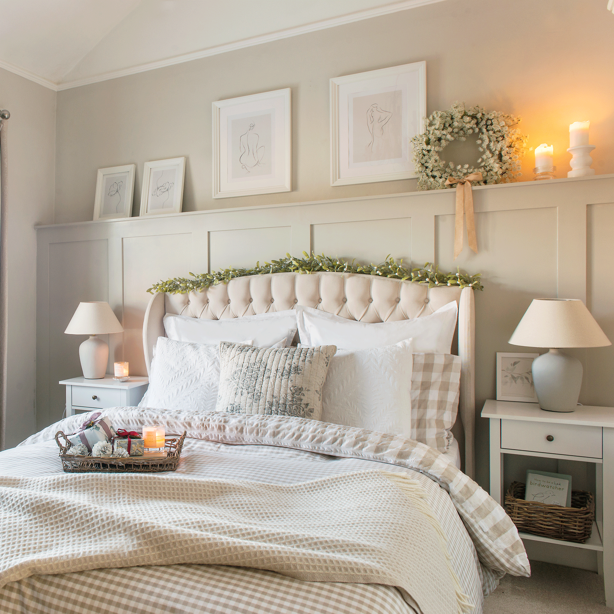 a neutral double bedroom with a padded button back headboard and wall panelling