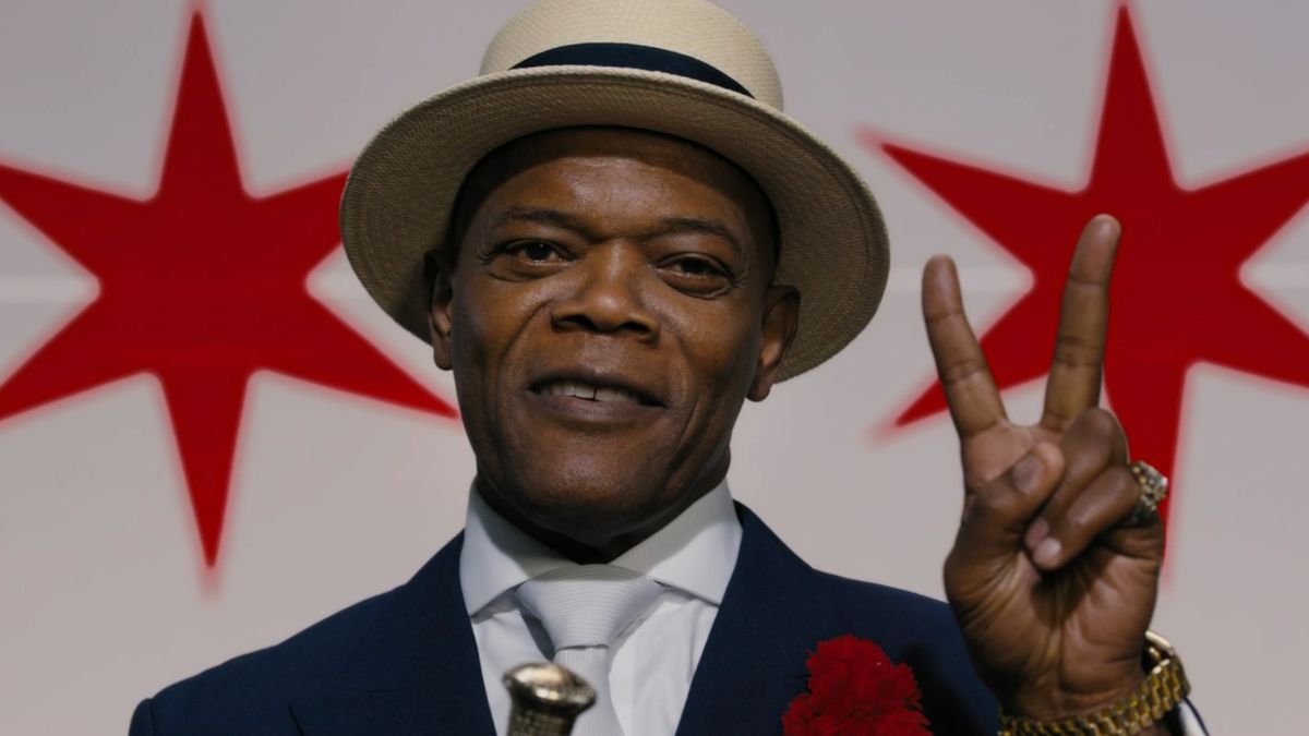 Samuel L Jackson flashes the peace sign in front of the Chicago flag in Chi-Raq.