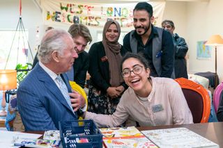 Britain's Prince Charles, Prince of Wales (L) has a chat with Betul an asylum-seeker from Turkey during a visit to the West London Welcome community centre, in London, on April 28, 2022. - West London Welcome community centre is run for, and with, refugees, asylum seekers, migrants and other locals living in west London.