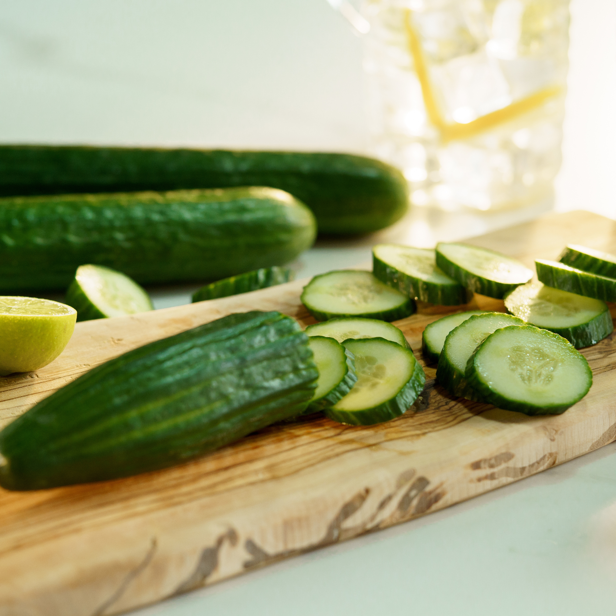 Sliced cucumber on a chopping board.