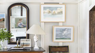 neutral hallway with seascape artwork and table lamp