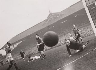 A shot heads for the camera, Manchester United versus Sheffield Wednesday, 1949. A photograph of a football match between Manchester United and Sheffield Wednesday in 1949. A shot wide of the post by United's Stan Pearson heads for the Daily Herald's photographer Bert Abell.
