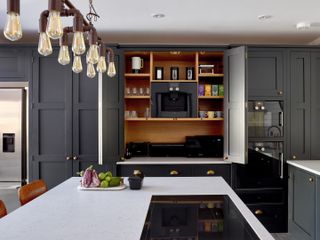 kitchen with dark interiors and larder by Higham Furniture