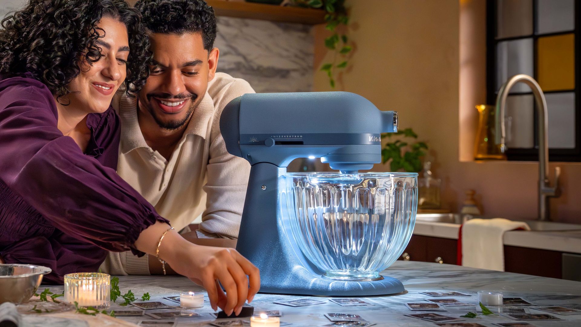 Man and woman with KitchenAid Luminaire stand mixer