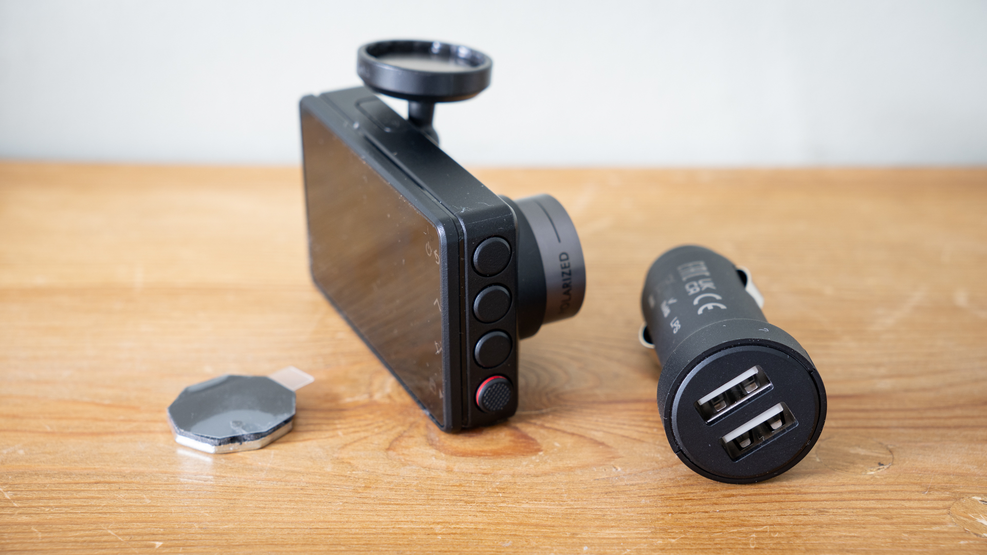 Garmin Dash Cam X210 on a wooden surface