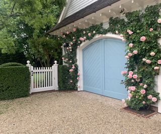 garage and gate with roses in front yard