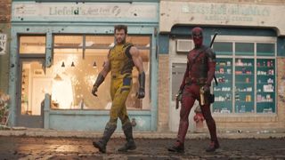 Deadpool and Wolverine standing side by side infront of damaged shops