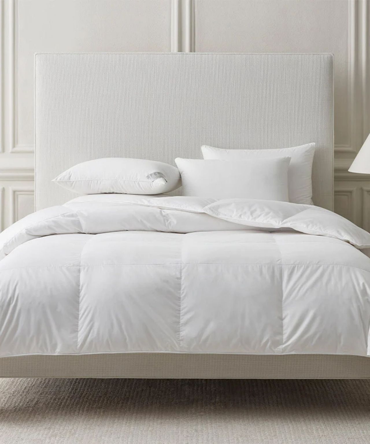 Sferra somerset duvet insert pictured on a white double bed in a white panelled bedroom with white carpet