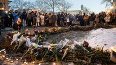 People mourn at a makeshift memorial for Alex Pretti, who was killed by ICE in Minneapolis.