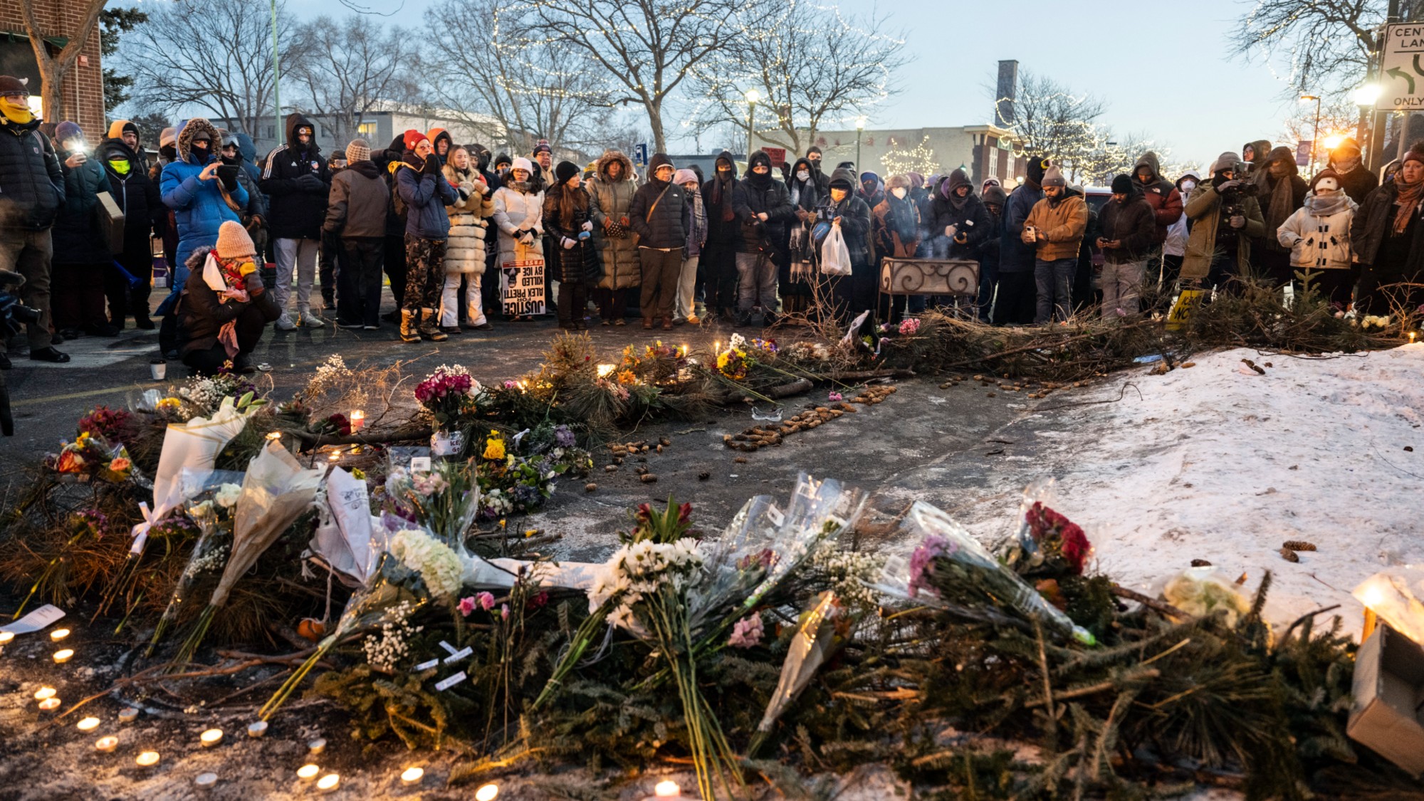 People mourn at a makeshift memorial for Alex Pretti, who was killed by ICE in Minneapolis.