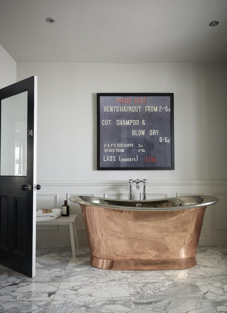 modern marble bathroom with copper freestanding bath