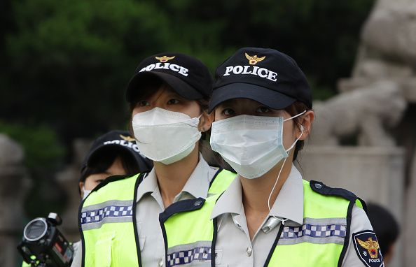 South Korean police officers protect themselves against MERS.