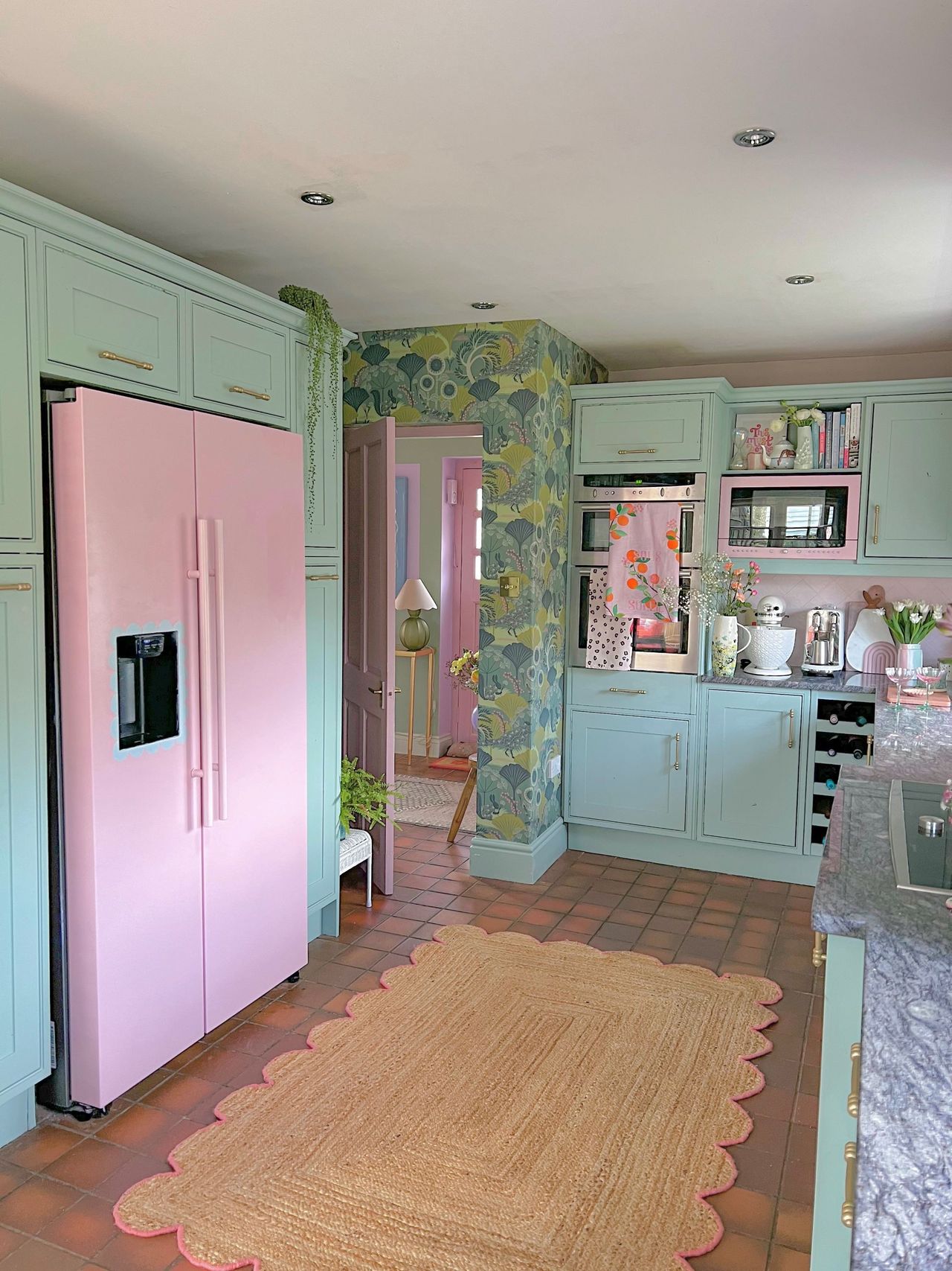 Kitchen given 'barbie' makeover with pink fridge and pink surfaces