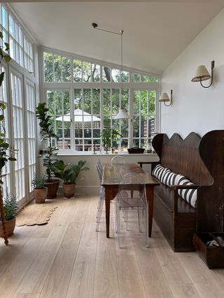 sunroom with indoor plants and dark wood furniture