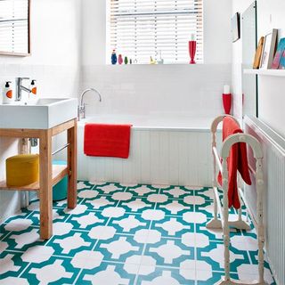 white bathroom with geometric floor tiles and open basin washstand