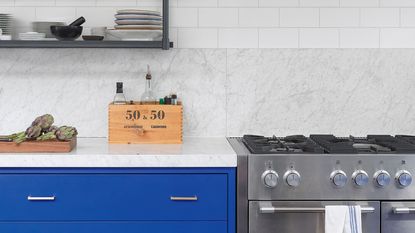 blue and white kitchen with steel cooker and gas stove