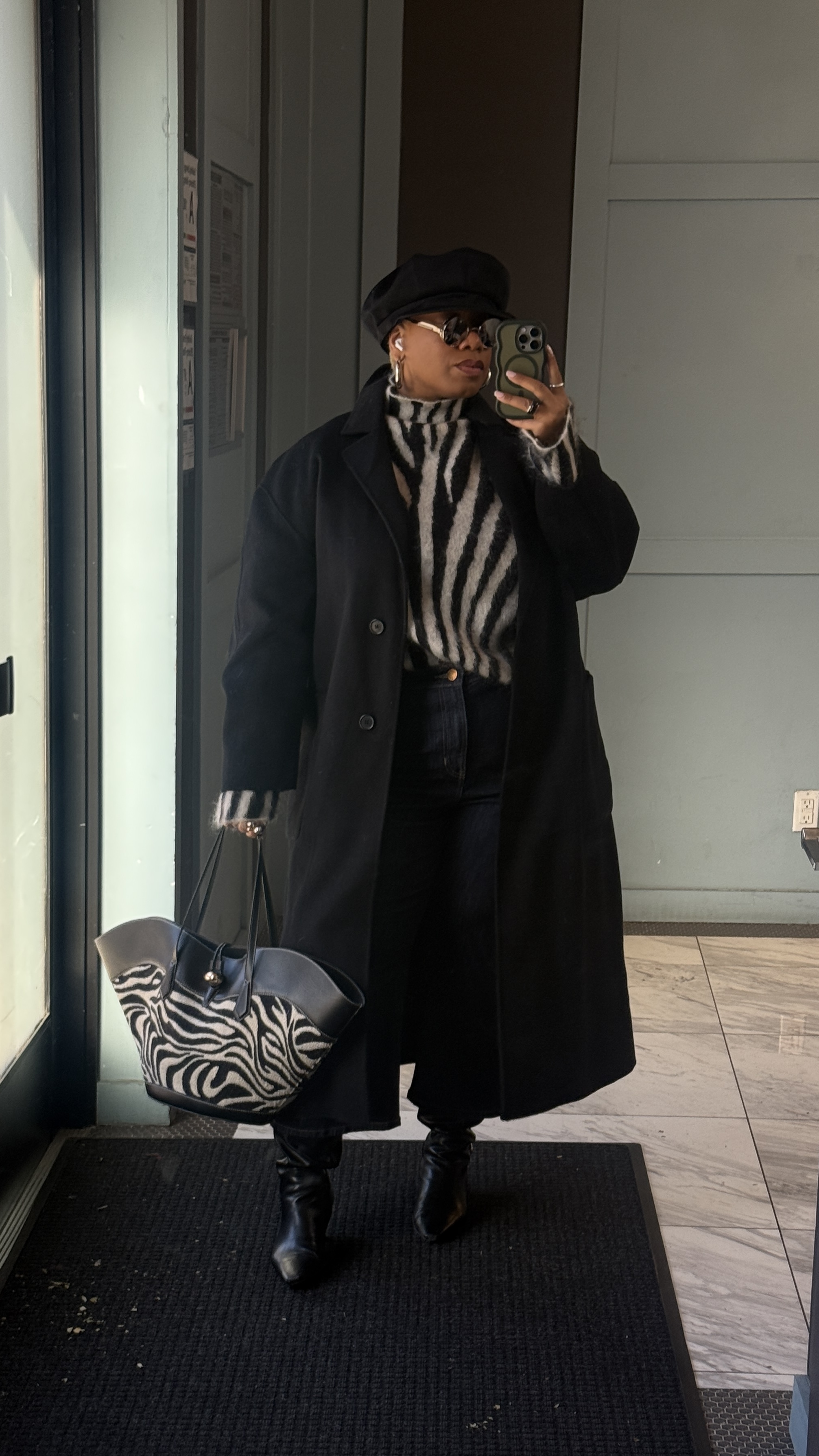 Kelly Augustine wearing a zebra print top and bag