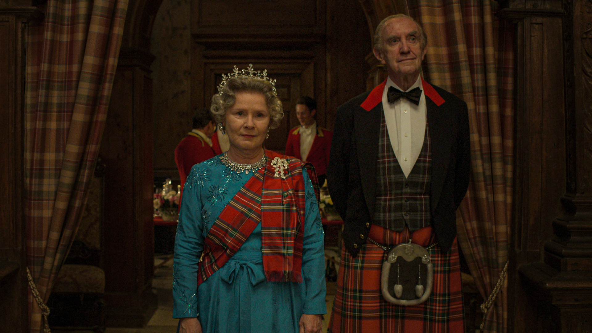 Queen Elizabeth II and Prince Phillip stand in tartan clothes in The Crown season 5