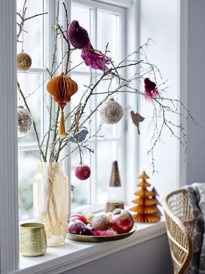 Christmas window decor vase of decorated branches