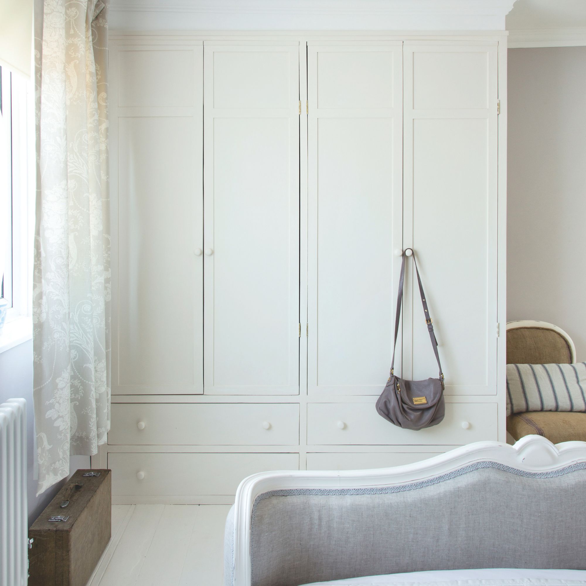 White fitted wardrobes in a white bedroom