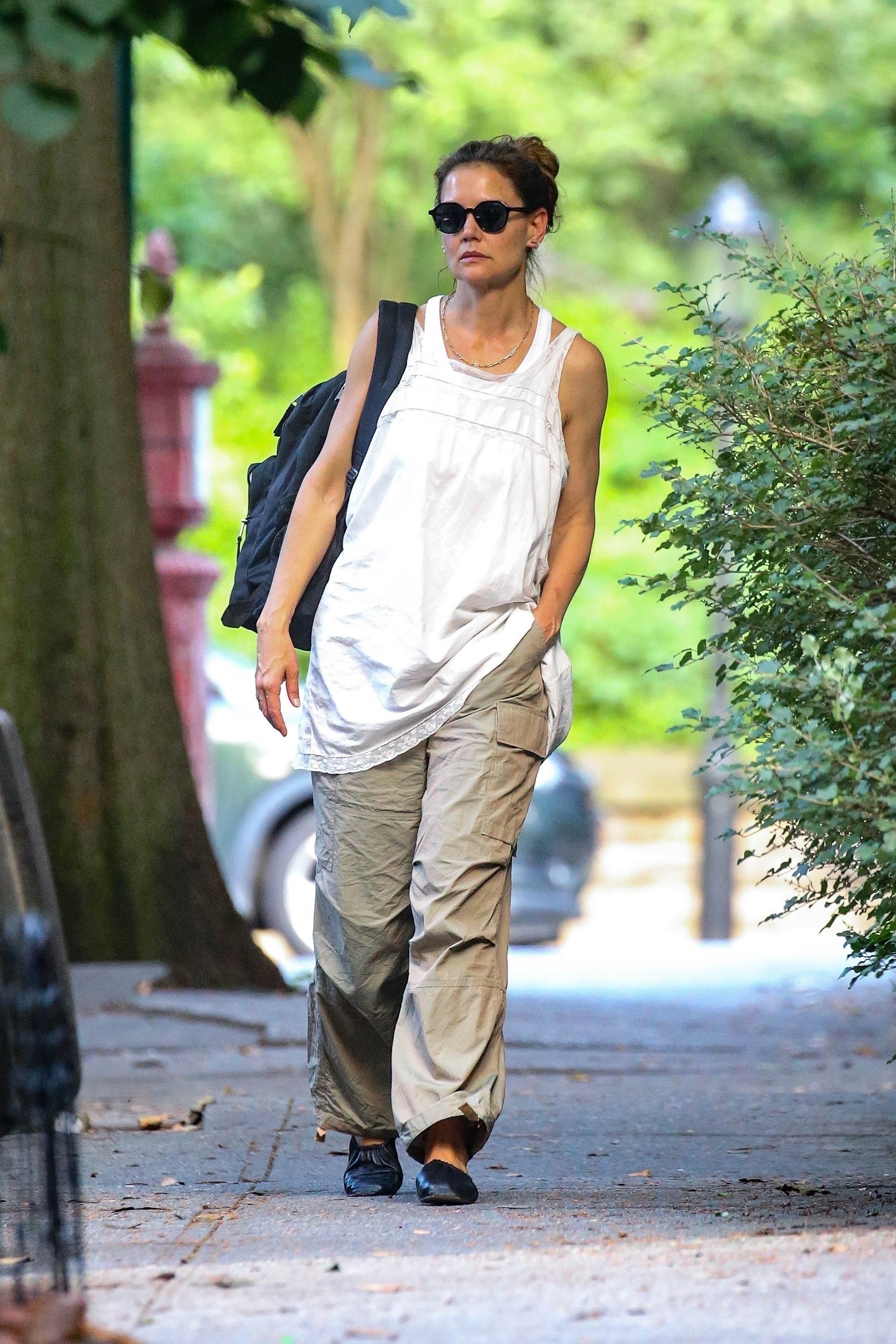 Katie Holmes wore khaki pants and a babydoll dress as a shirt in NYC