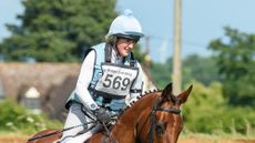 Image shows Sally Butler, pictured in 2021, wearing her pale blue cross-country colours and riding bay horse Diamonds Eclipse.