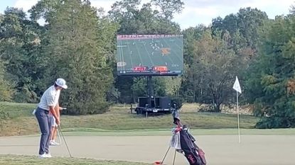 A big screen beside the green at the Golf Club of Georgia Collegiate