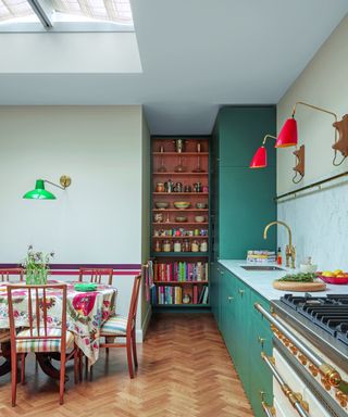 kitchen with green cabinets, wooden flooring and table with patterned tablecloth