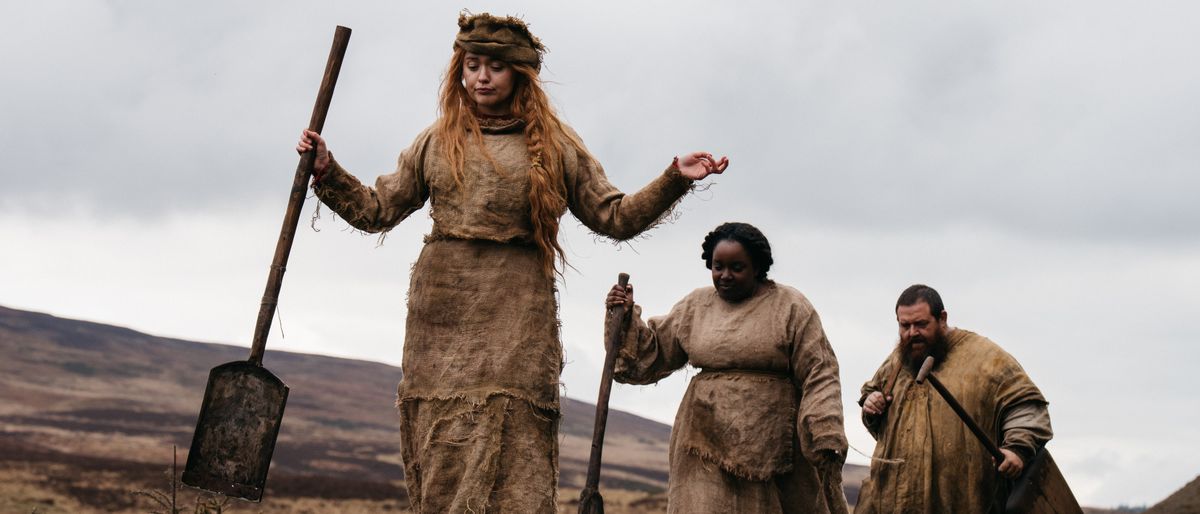 Queen Dagan (Aimee Lou Wood), Shulmay (Lolly Adefope), and Bobik (Nick Frost) (L-R) dressed in rags in Seize Them! 