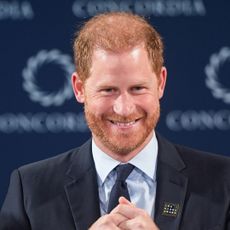 Prince Harry smiles onstage while wearing a suit at the 2024 Concordia Annual Summit in New York on September 23, 2024