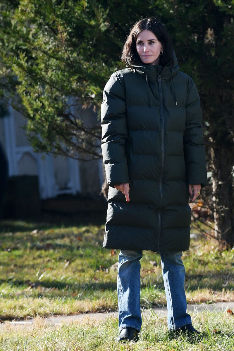 Courteney Cox in a puffer coat and straight leg jeans