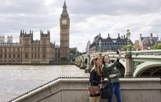 People take a selfie in front of the Houses of Parliament