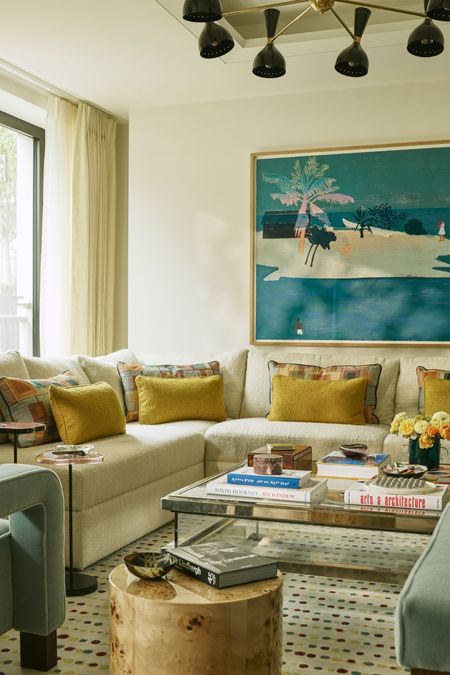 a warm neutral open plan living room with yellow and blue color palette