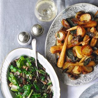 Roast potatoes, parsnips and vegetables in serving dishes