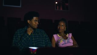 Michael Cooper Jr. as Justin Edwards and Lovie Simone as Keisha Clark smiling at each other in a movie theater in Forever on Netflix