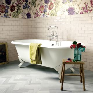 bathroom with white tiled walls and floral printed wallpapers