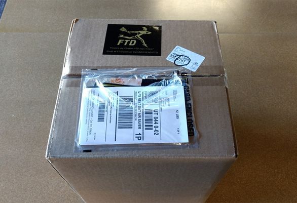 FTD includes a free personalized card that is secured on the outside of the box.