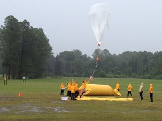 Researchers launch a weather balloon during a thunderstorm on a golf course a few miles east of Starke, Fla., as part of an effort to better understand what causes lightning to form.