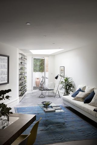 narrow white living room with blue and grey scheme