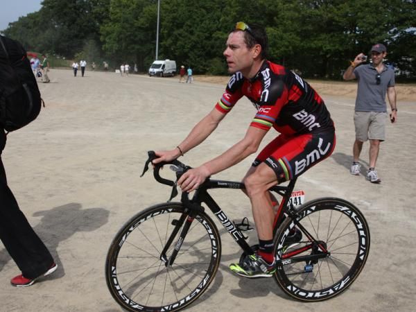 Cadel Evans (BMC) calmly rolls towards his team bus with team press agent Georges Luechinger leading the way.