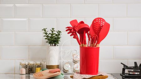 Red silicone cooking utensils in red container