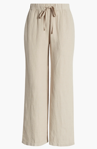 a pair of linen pants in front of a plain backdrop