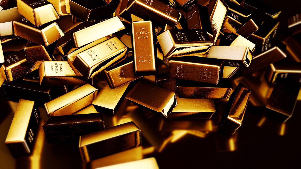 Gold bars tumbling against a black backdrop