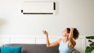 Young woman feeling sweaty during a heatwave because her air conditioning is not working
