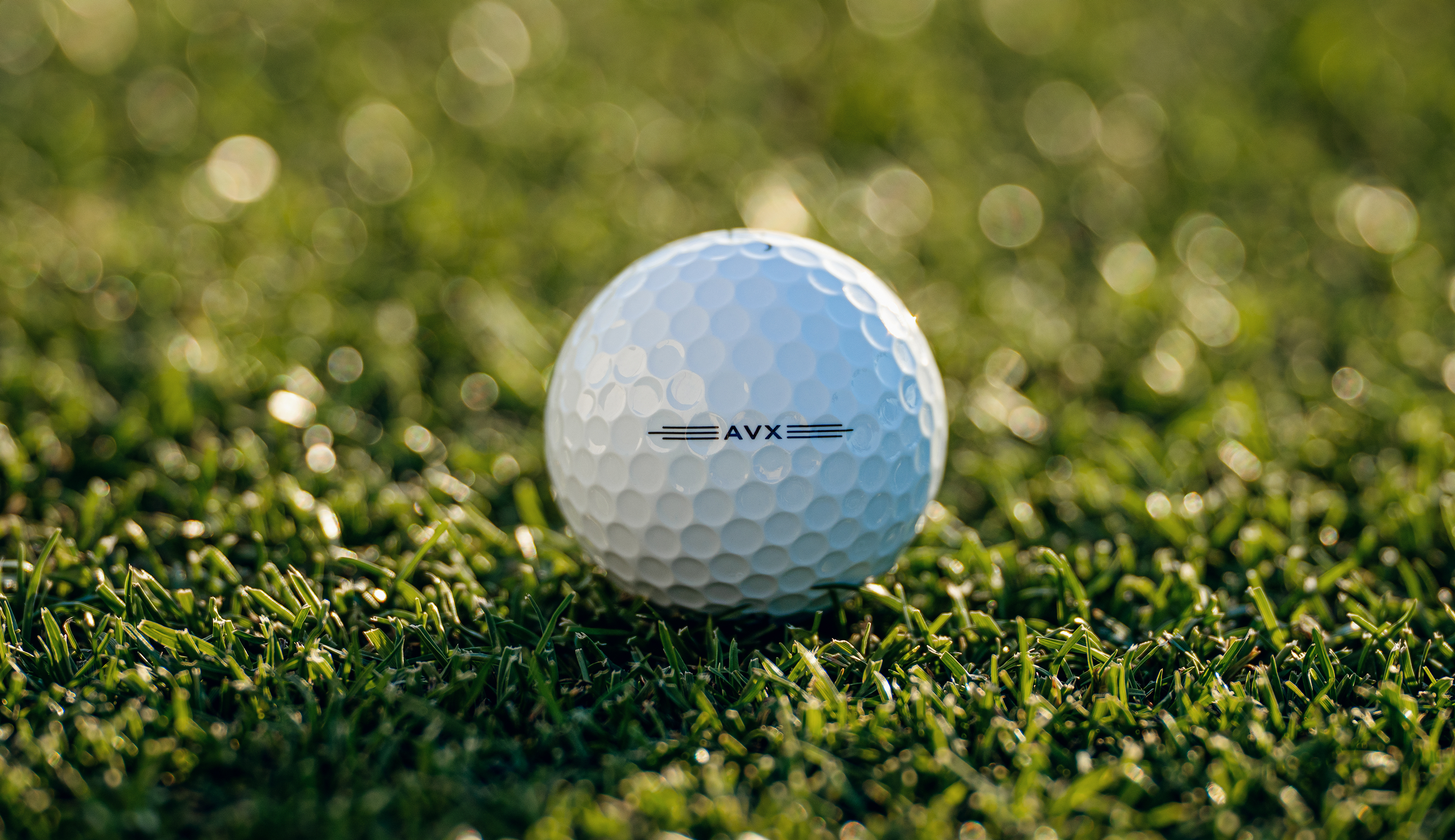 A close up of the Titeist AVX golf ball