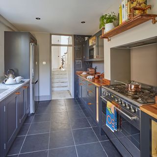 kitchen with grey cabinets and wooden worktop