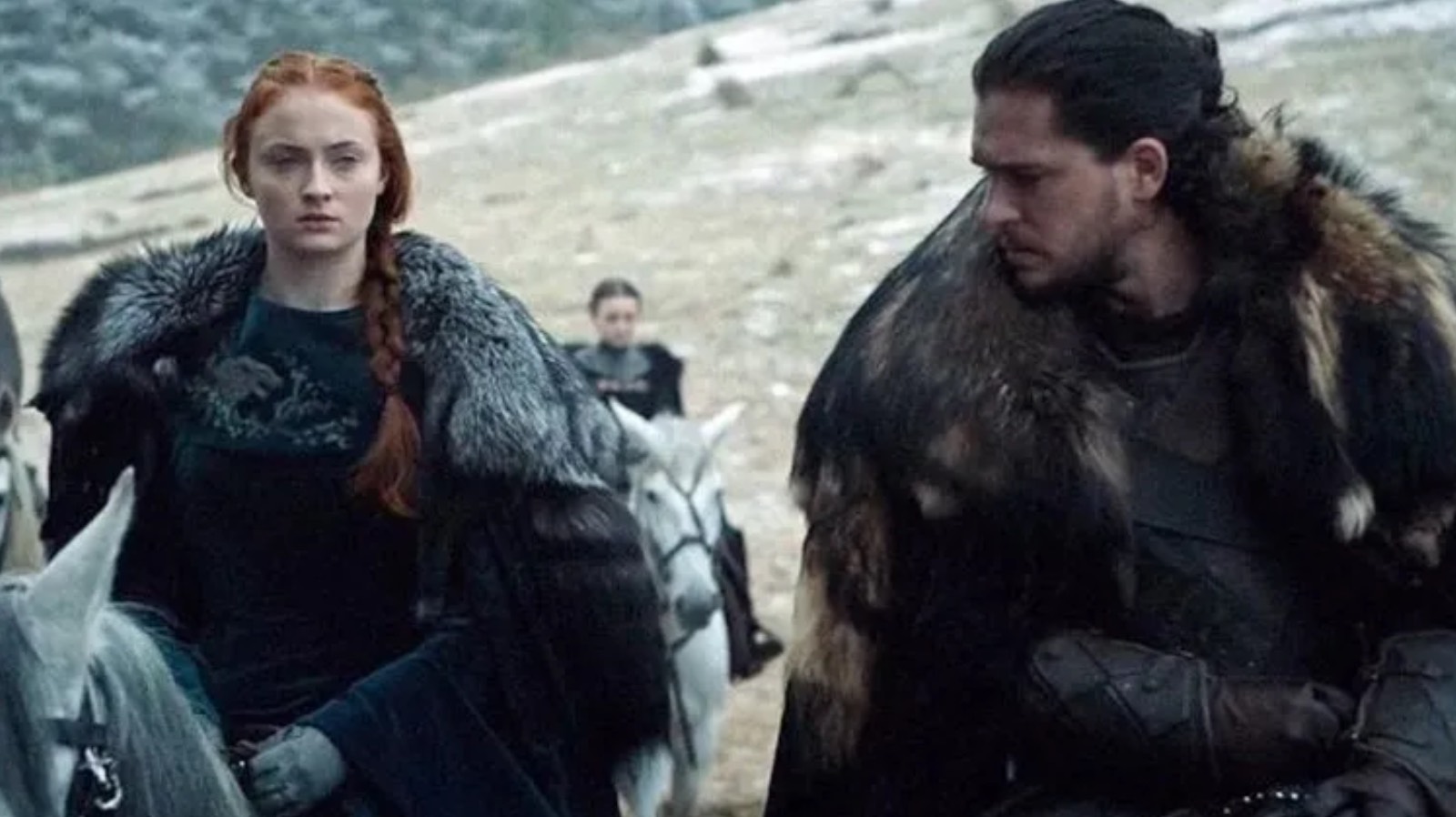 Sansa Stark and Jon Snow riding horses alongside each other