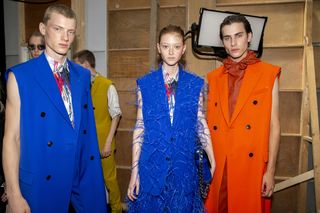 Berluti models wearing bright orange and blue clothing