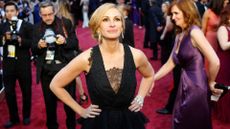 Julia Roberts at the Oscars 2014 in one of the best red carpet looks of the 2010s, smiling and looking up at the camera 